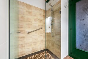 A glass-enclosed shower with a handrail, tiled walls, and a patterned floor. - Vacation Home "Mas Lucena" with Private Pool, Private Terrace & Wi-Fi (Alforja)