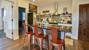 A modern kitchen with a central island, stainless steel appliances, and a backsplash. - Moab Digs #2 - Your Downtown Basecamp! (Moab)