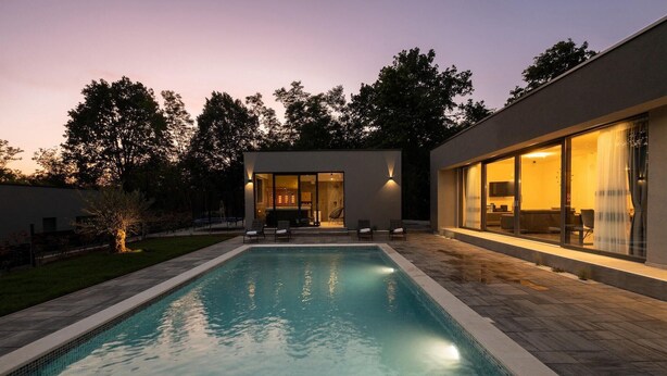A modern house with a swimming pool, a patio with chairs, and a large window overlooking the pool. - Amazing home in Nedescina with sauna (Nedescina)