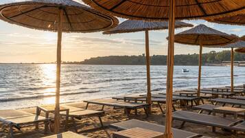 Sun-loungers, beach umbrellas, beach towels, beach volleyball