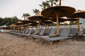 Sun-loungers, beach umbrellas, beach towels, beach volleyball