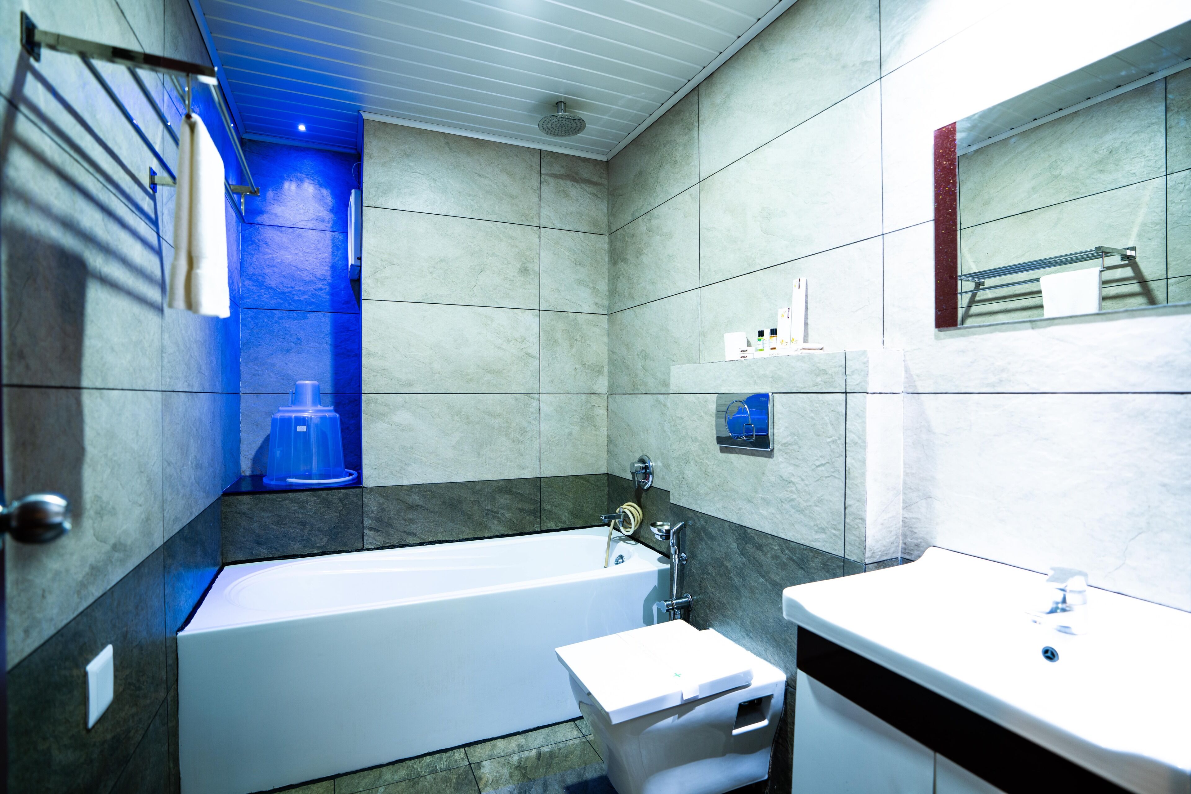 A modern bathroom with a bathtub, a sink, and a mirror.