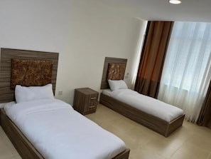 Egyptian cotton sheets, premium bedding, desk, laptop workspace - Rayan Hotel Suites (Amman)