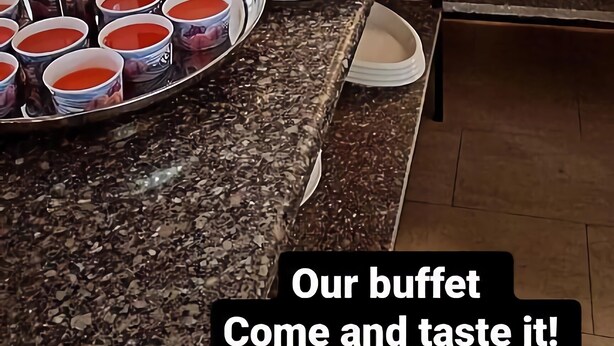 A buffet with various food items and a sign that reads "Our buffet Come and taste it!". - Rayan Hotel Suites (Amman)