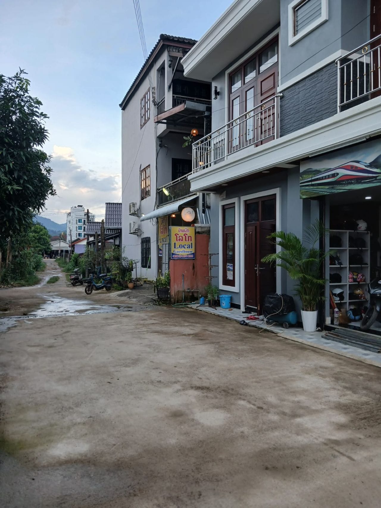 A two-story building with a ground-level shop and a balcony on the upper floor.