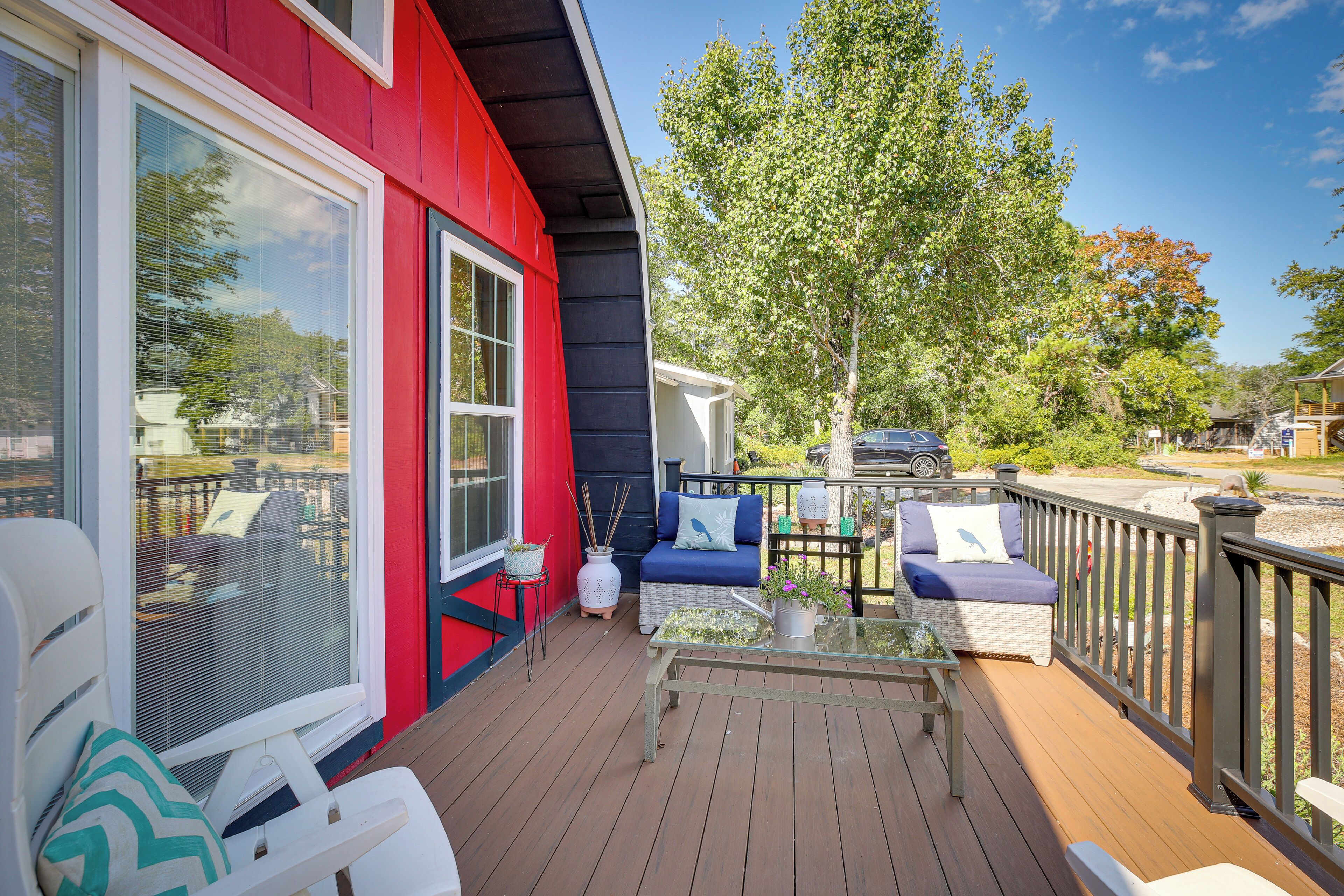 Una terraza con mobiliario exterior, una mesa de vidrio y vistas del entorno.