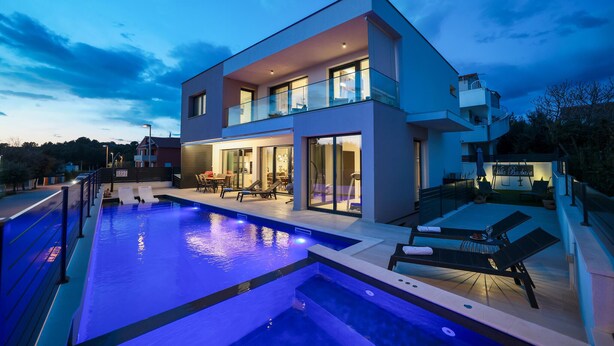 A modern two-story house with a swimming pool, outdoor seating, and a visible balcony. - Villa Barbara Pakostane (Pakostane)