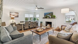 A spacious living room with a fireplace, a dining area, and a cozy seating arrangement.