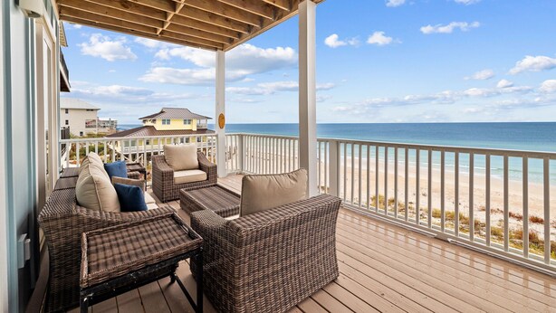 A covered outdoor seating area with wicker furniture and a view of the beach. - Family Beach Retreat w/Pool and Elevator (Port St. Joe)