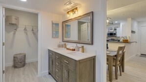A modern bathroom with a large vanity, double sink, and a mirror above. - Avalon. Fully renovated 2024. Pool view (Clearwater)