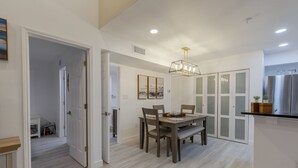 A modern kitchen with a stainless steel refrigerator, a wooden countertop, and a dining area with a table and chairs. - Avalon. Fully renovated 2024. Pool view (Clearwater)