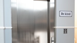 An elevator with a digital display, a "Be kind" sign, and a no-smoking sign. - Villa Tosati (Monza)