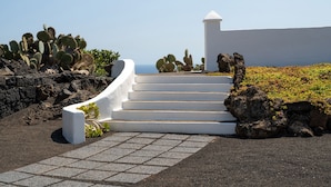 A white staircase leading to a building with a clear view of the sea. - Las Pergolas Villa Rural - Apartamento Yaiza (Tías)