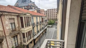 A balcony with a view of a street lined with buildings. - Hostal Sol (Zamora)