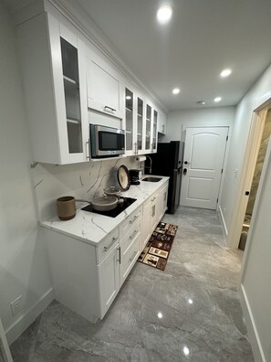 Fridge, microwave, stovetop, coffee/tea maker