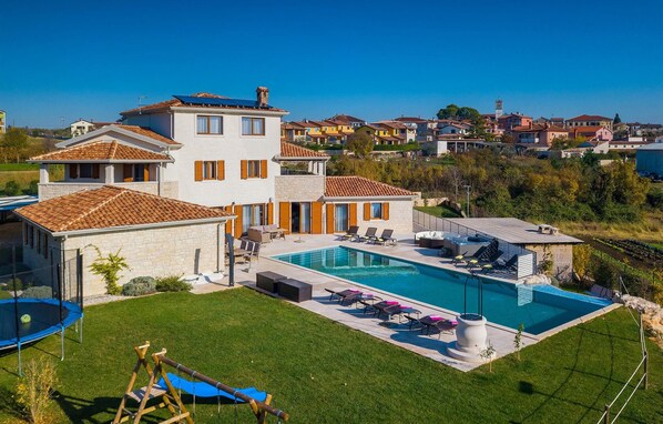 Enjoy a relaxing stay in this two-story house with a spacious backyard, swimming pool, and large patio area.