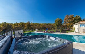 Relax by the pool, where a hot tub and lounge chairs await.