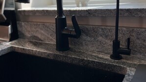 A kitchen sink with a modern faucet and a window above it. - Beach Bunker Minute Walk To Beach and Pier at Old Orchard Family-Friendly Cozy (Old Orchard Beach)