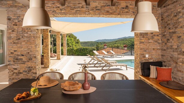 A terrace with a pool, lounge chairs, and a table with food and drinks. - Amazing home in Labin - Rabac (Labin - Rabac)