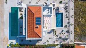 An aerial view of a resort with a swimming pool, a separate pool, and a covered patio area. - Stunning home in Porec (Porec)