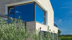 A modern building with large windows and a stone facade. - Awesome home in Novigrad (Novigrad)