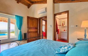 Enjoy a restful stay in this well-appointed room with a large bed, bathroom, and sea view.