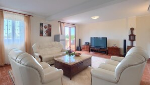 A spacious living room with a sofa set, a coffee table, a television, and a piano. - Stunning home in Liznjan with sauna (Liznjan)