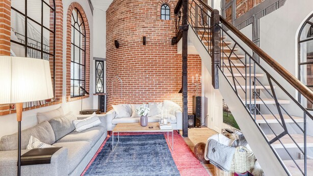 A cozy living room with a fireplace, a sofa, a coffee table, and a staircase leading to an upper level. - Awesome home in Ausacker with WiFi (Ausacker)