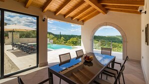 A spacious patio with a pool, outdoor seating, and a view of the surrounding landscape. - Amazing home in Pazin (Pazin)