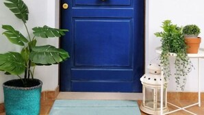 A blue door with a sign that reads "Home."