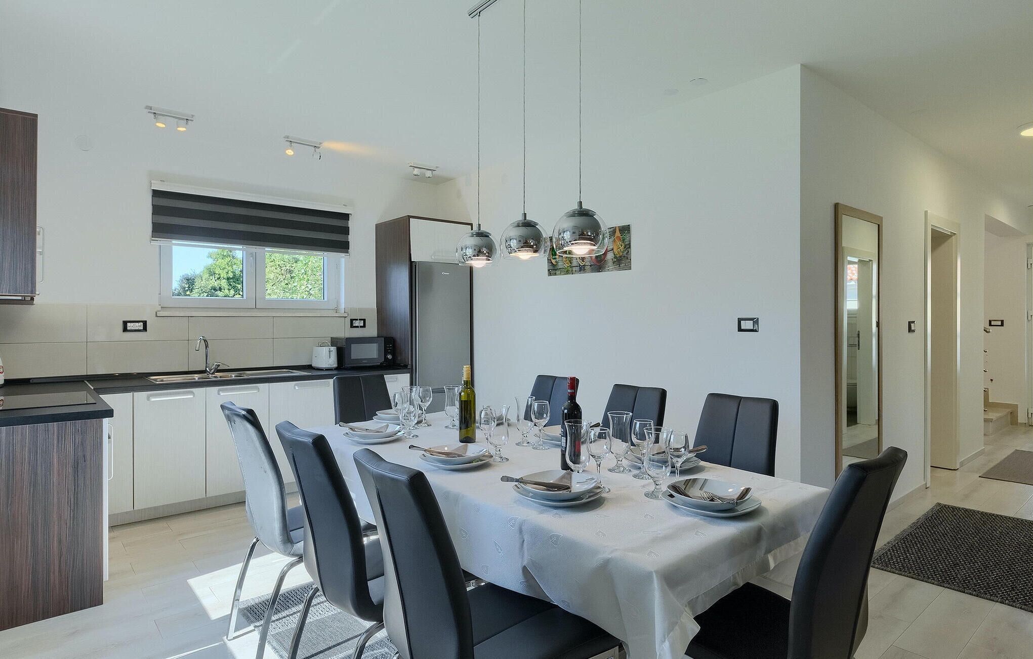 A modern kitchen with a dining area.