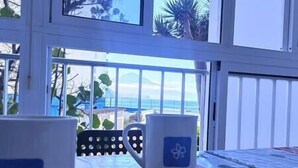 A room with a view of the ocean, a table with two mugs, and a chair. - NEAR THE SEA IN MESA DEL MAR (Mesa del Mar)