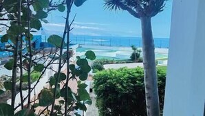 A view from a balcony overlooking a pool area with a clear sky. - NEAR THE SEA IN MESA DEL MAR (Mesa del Mar)