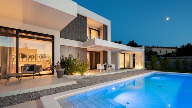 A modern two-story house with a swimming pool, outdoor seating, and a well-lit interior. - Lovely home in Labin - Rabac (Labin - Rabac)