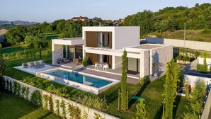 A modern two-story house with a swimming pool, outdoor seating, and a view of the surrounding landscape. - Lovely home in Labin - Rabac (Labin - Rabac)