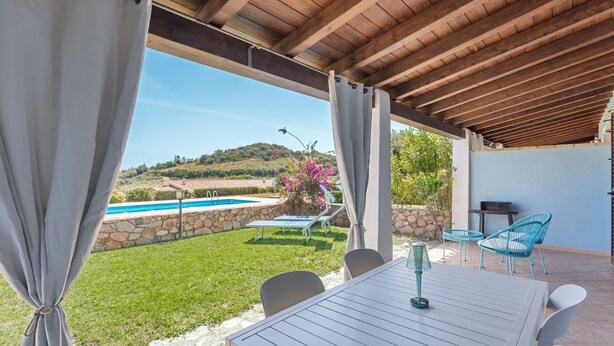 A covered outdoor area with a pool, chairs, and a table. - La Casa Azzurra with shared Pool (Tertenia)