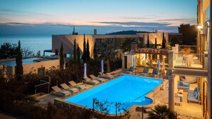 A rooftop pool area with lounge chairs and a pergola, overlooking a body of water. - Beautiful home in Rogoznica with sauna (Rogoznica)