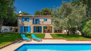 A two-story stone house with blue shutters, a swimming pool, and two lounge chairs. - Pet friendly home in Pula (Pula)