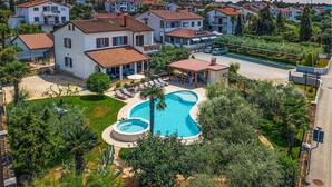 A residential area with a large swimming pool, multiple houses, and a restaurant named MEDUSA.
