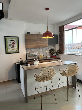 Full-size fridge, microwave, blender, cookware/dishes/utensils