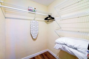 A small, neatly organized room with a bunk bed, a drying rack, and a wall-mounted ironing board. - Apt w/ Free Parking | Stay in Little Havana (Miami)