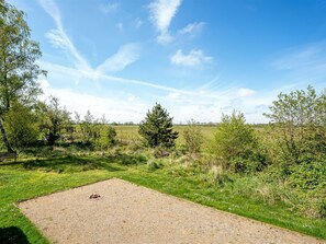 A gravel area with a bench and a fire pit.