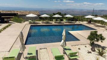 Seasonal outdoor pool, open 9:00 AM to 7:00 PM, pool umbrellas