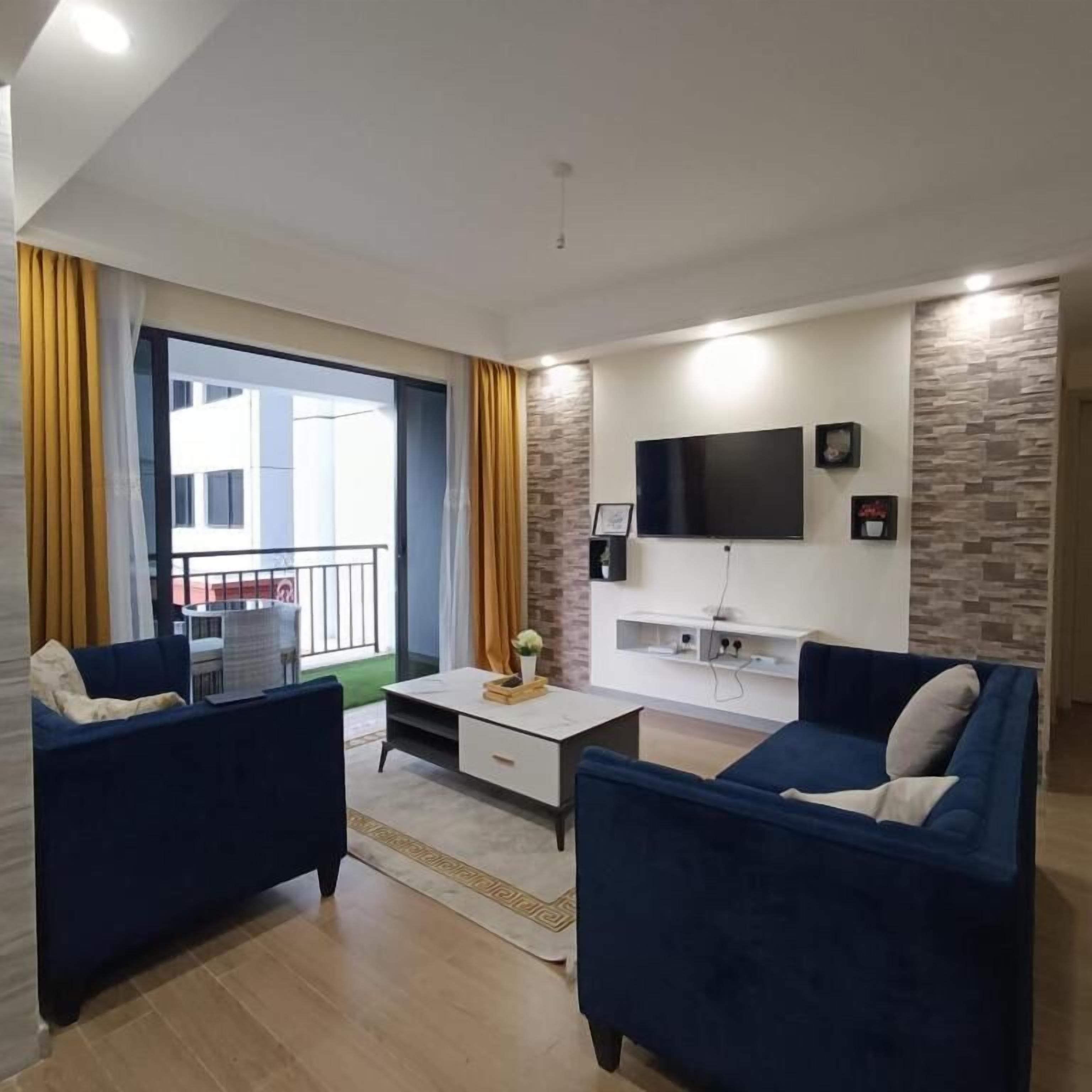 Business Apartment | Living area | 24-inch Smart TV with satellite channels
