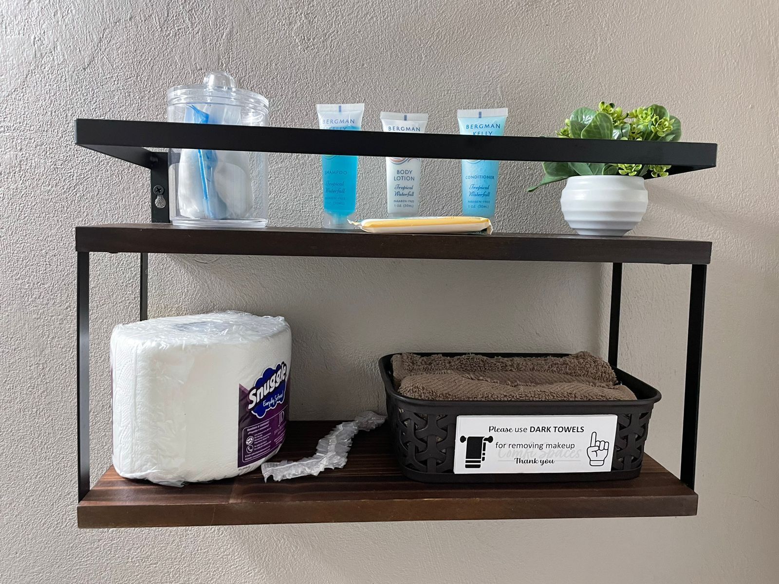 A shelf with personal care items, a tissue roll, and a pet bed.