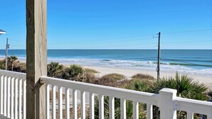 A wooden deck with a white railing overlooking a beach with waves and a clear blue sky. - Oceanfront 4BR, Pool & Elevator | Surf City Beach (Surf City)