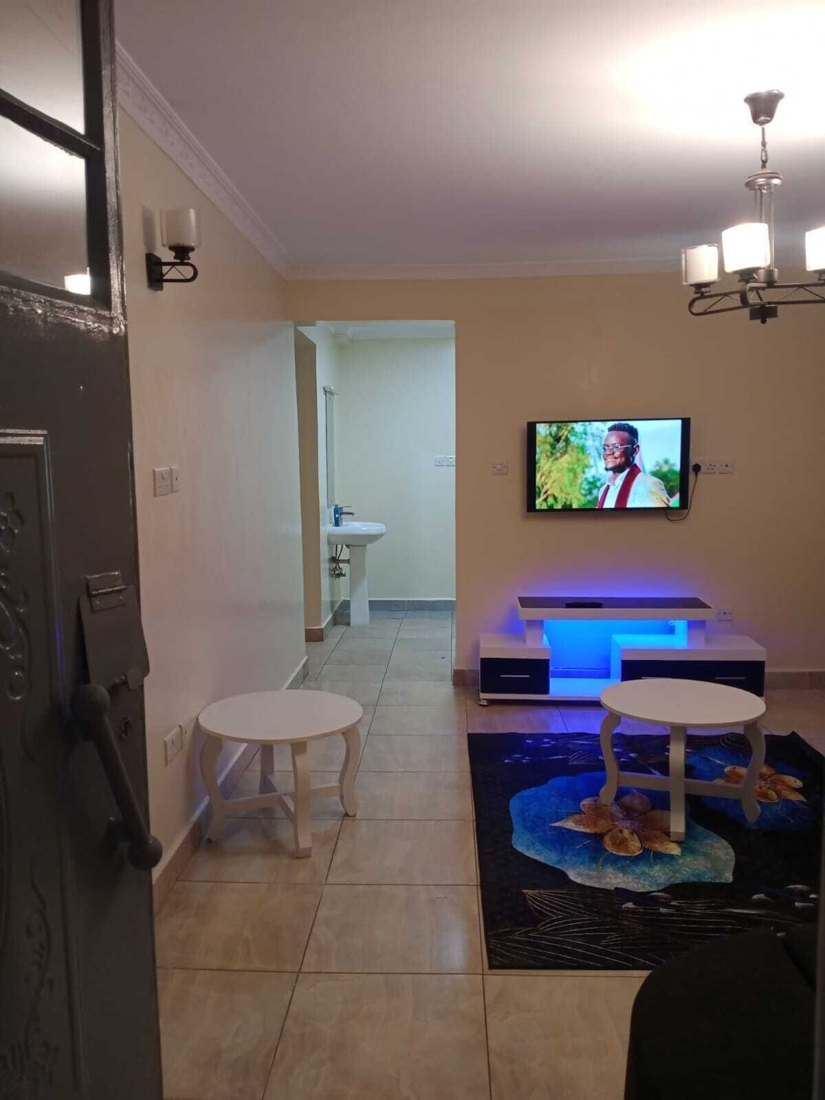 Business Apartment | Living area | 24-inch Smart TV with satellite channels