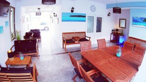 Relax in the spacious living area with a large dining table and comfortable seating.