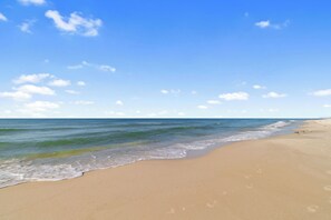 A beach with clear skies and calm waters.