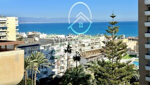 A coastal residential area with a view of the sea, featuring multi-story buildings with balconies and a clear sky. - 2 bedrooms apartment in front of the sea with stunning views! (Torremolinos)
